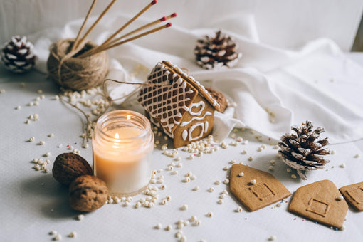 scented candle and miniature Christmas decorations